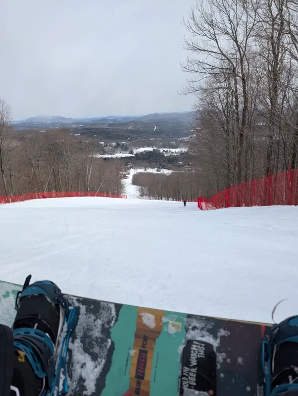 Snowboard at the top of a groomed run